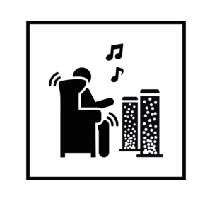 Una persona en un sillón escucha música de altavoces