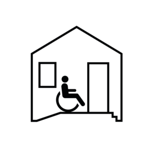 Casa con rampa y persona con silla de ruedas