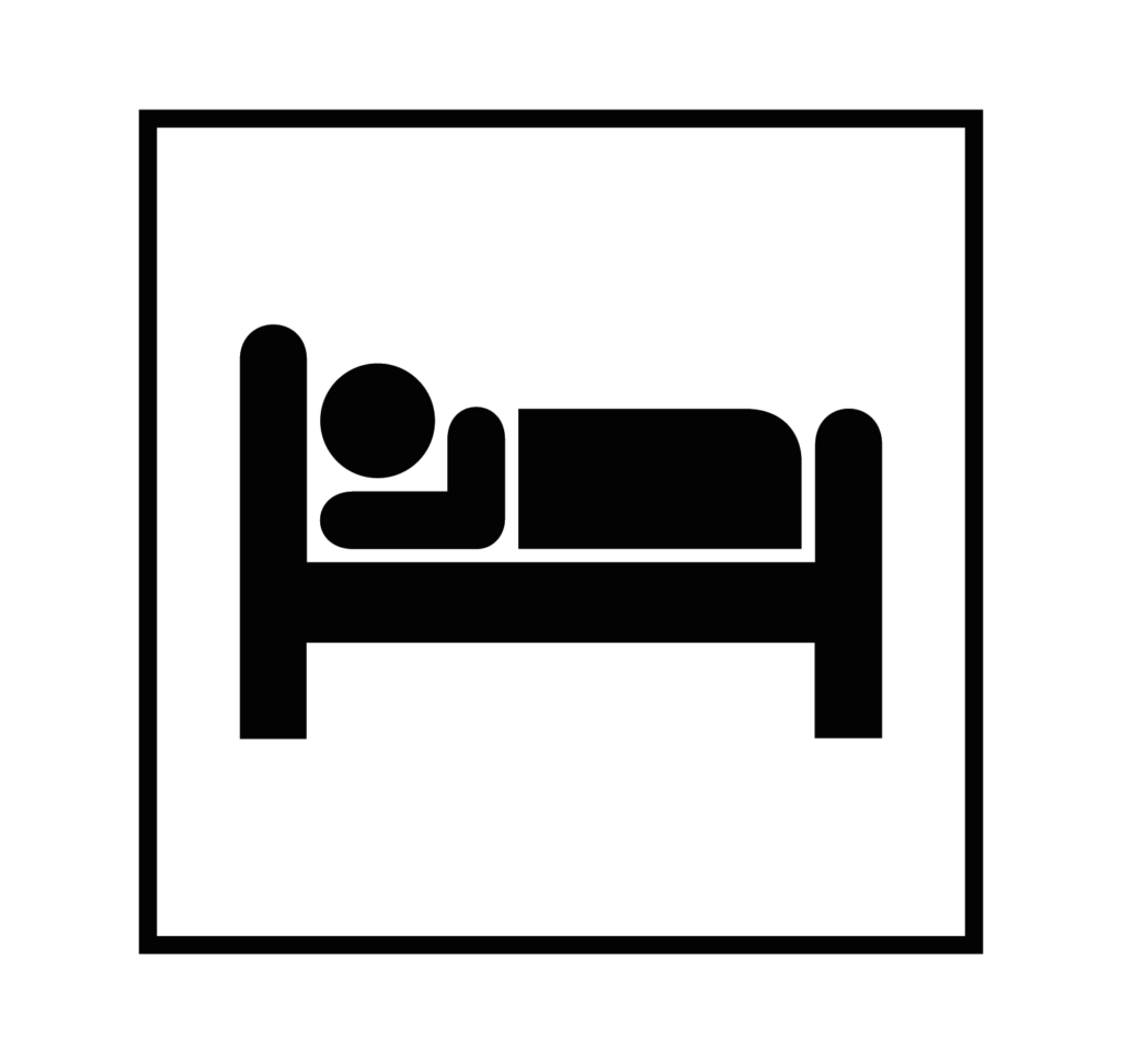 Una persona acostada en una cama con una sábada o manta encima